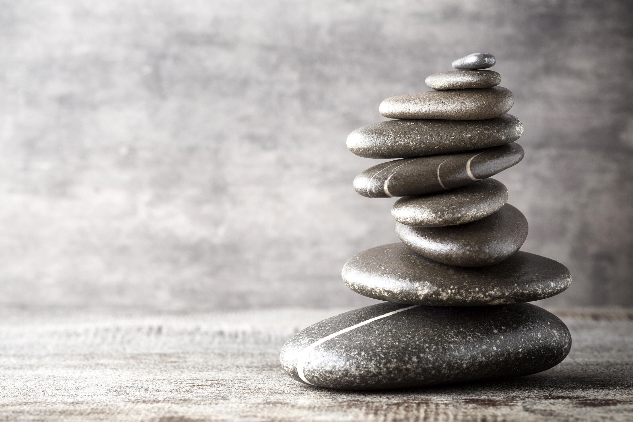 balancing-stones-on-the-grey-background-AXP4JMV